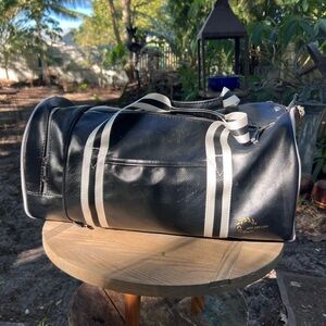 Stylish Black Duffel Bag with White Accents by And the Like